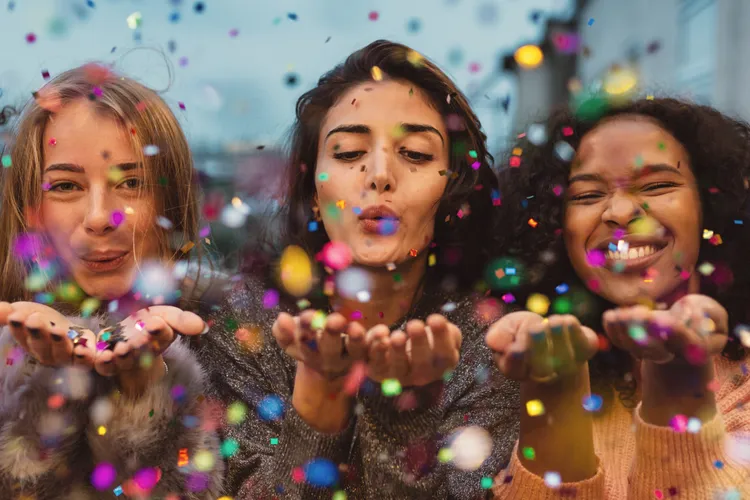 women celebrating compensation change